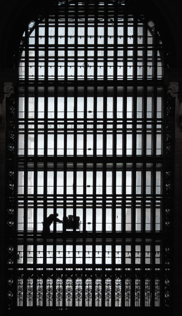 A worker is sillouetted while pushing a cart through Grand Central Station in New York City, New York, USA. Photographed by 8d Photos based in Clermont, Florida, USA.