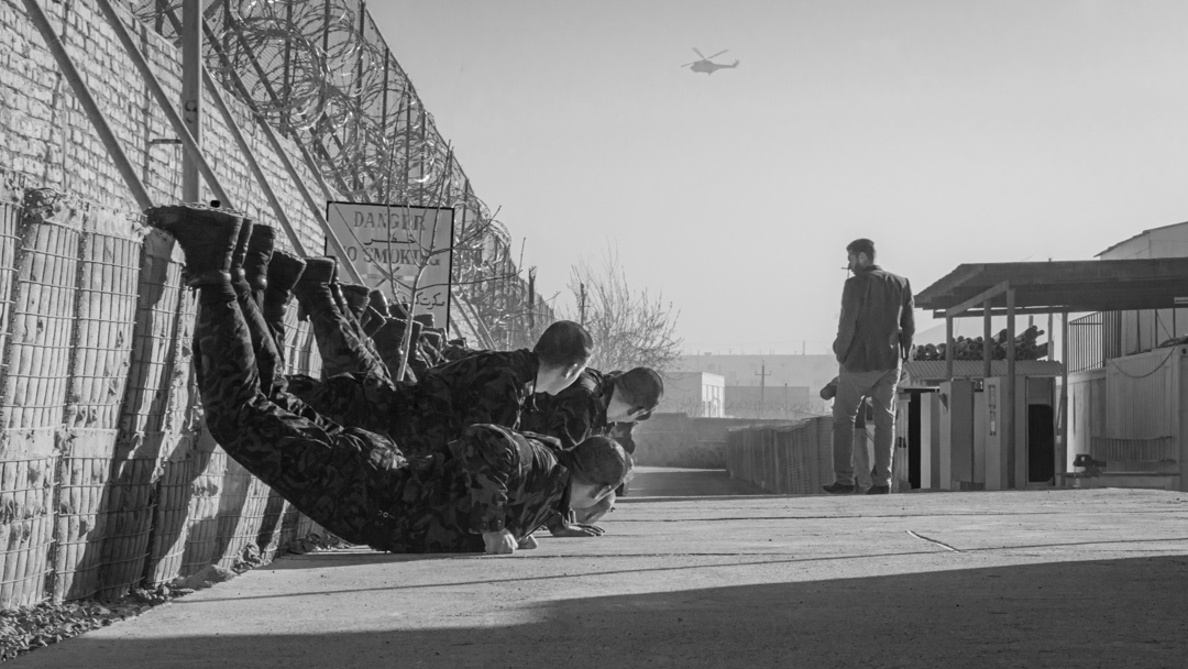 Afghan Presidential Protection Service candidates performing push-ups with their feet elevated on a HESCO wall at Camp Watan, Kabul, Afghanistan